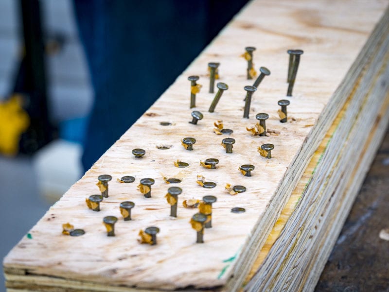 proud nails in stacked plywood