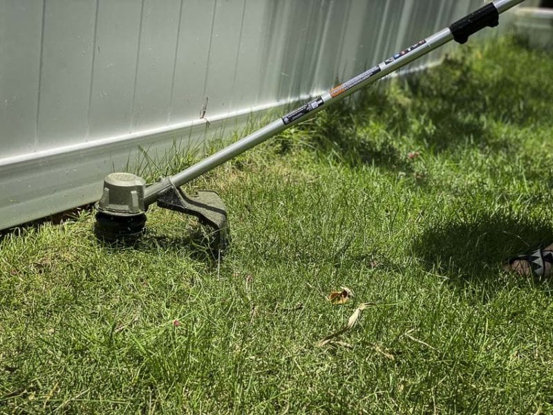 trimming underneath fence line